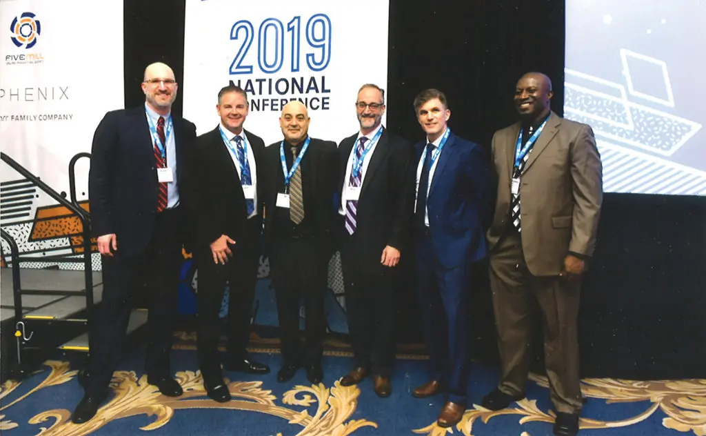 Ali Hodroj third from left receiving his award surrounded by Empire Today company executives