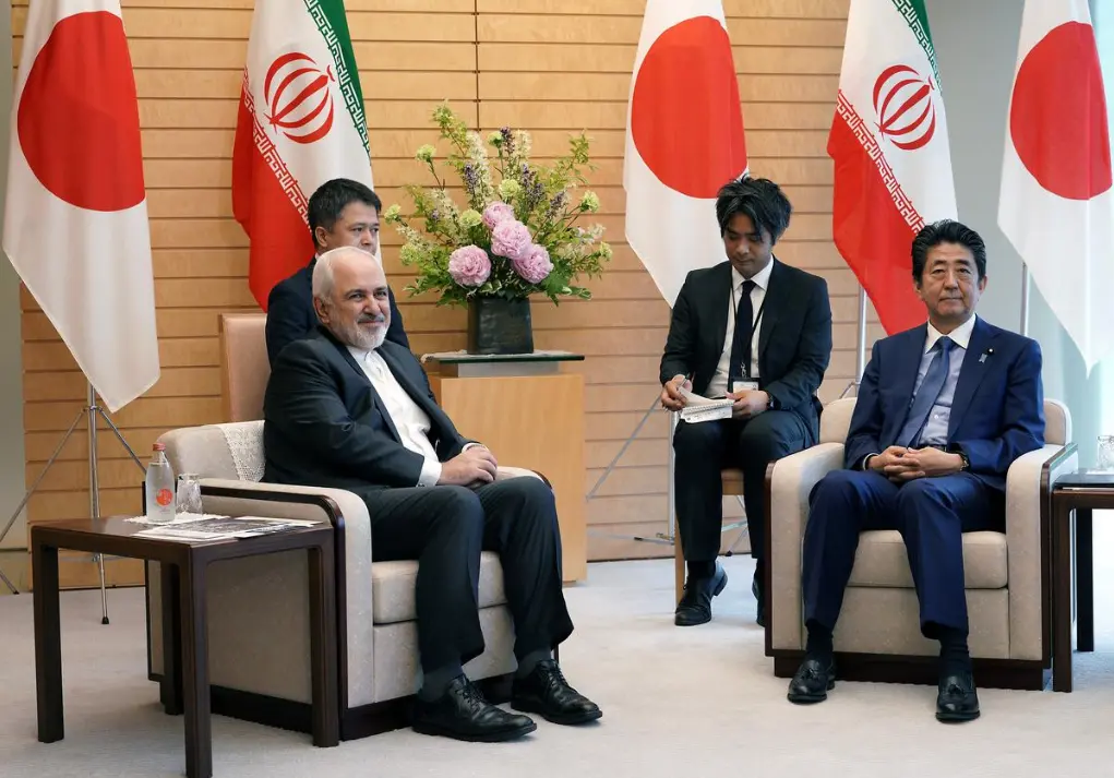 Iranian Foreign Minister Mohammad Javad Zarif, left, and Japanese Prime Minister Shinzo Abe, right, speak at Abe's official residence in Tokyo Thursday, May 16, 2019 - Reuters