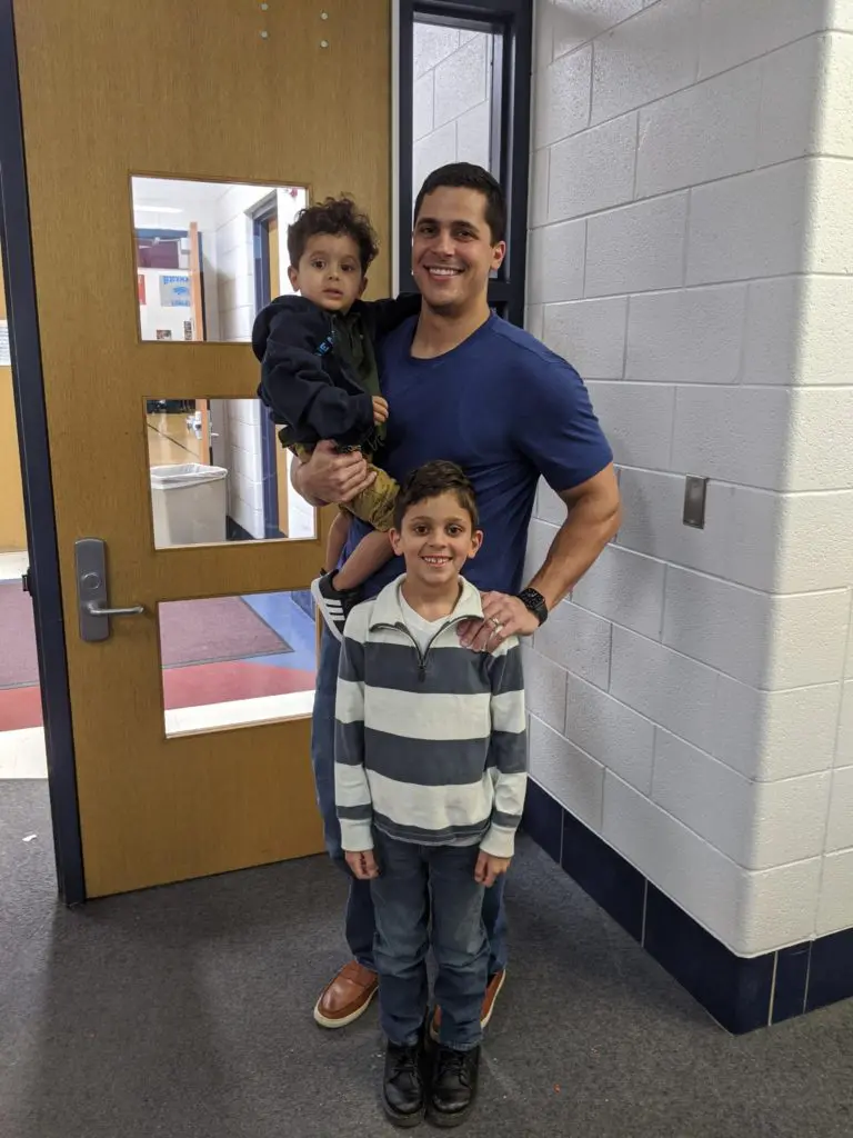 A voter, Mohammad Abdullah, with his sons Musa (top) and Issa (bottom), at Salina Intermediate School in Dearborn. Photo: Nick Meyer