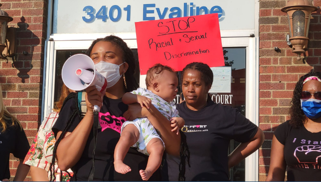 A protester addresses the crowd at July 27 demonstration in front of City Hall. Photo: Rasha Almulaiki / The Arab American News
