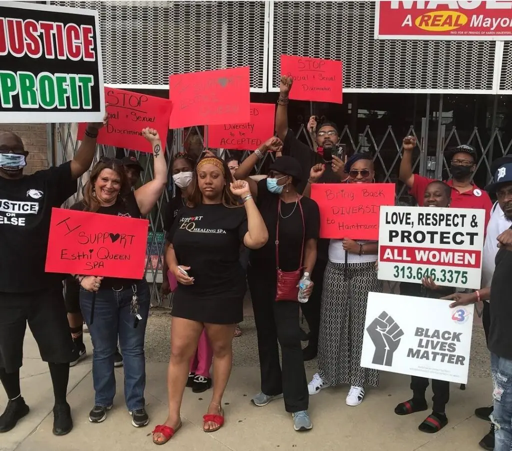 EQ Healing Spa owner poses with protesters in front of Hamtramck Mayor Karen Majewski owned Tekla Vintage store. Photo: Tiara Boyd