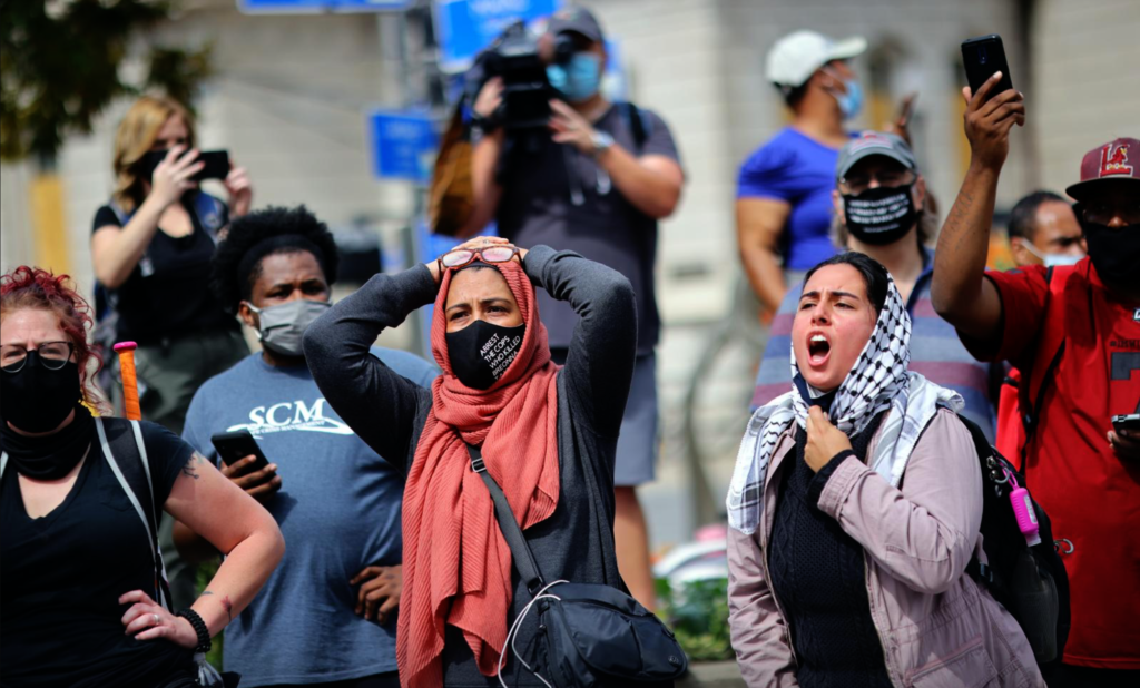 People react after a decision in the criminal case against police officers involved in the death of Breonna Taylor, who was shot dead by police in her apartment, in Louisville, Kentucky.