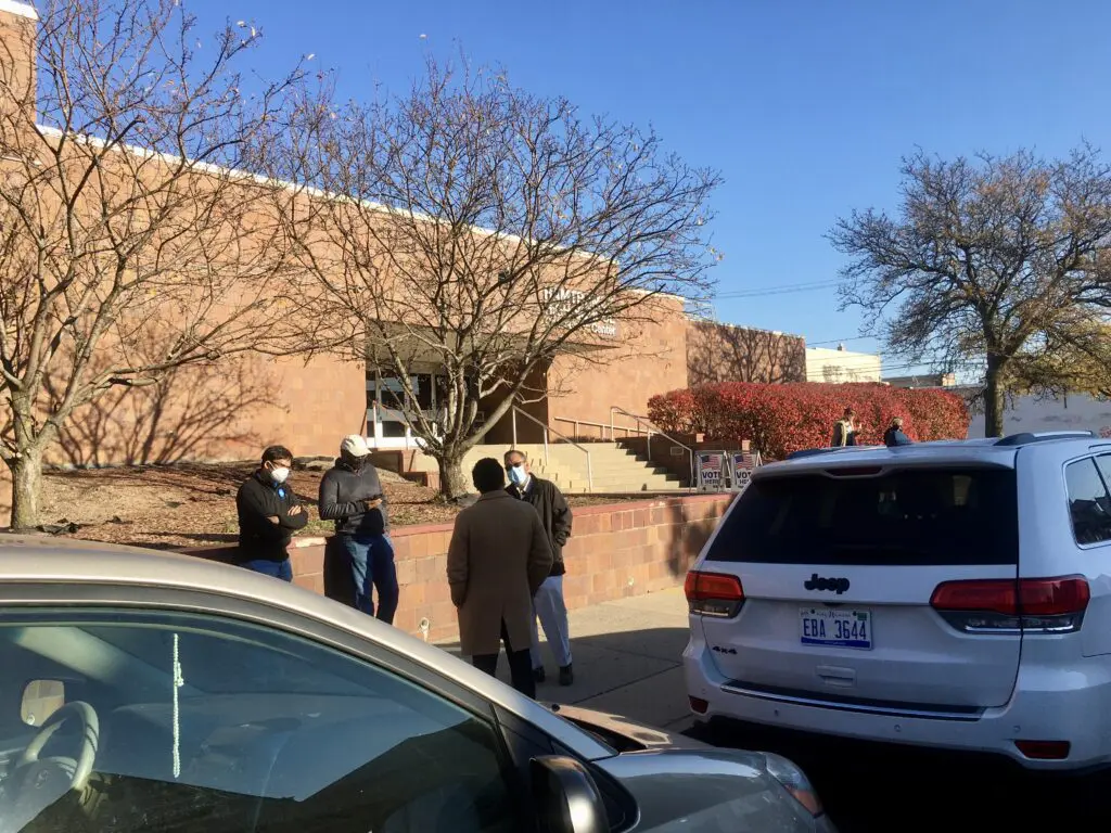 Voters stand outside the Hamtramck High School, which houses three precincts, in Hamtramck, Tuesday, Nov. 3.