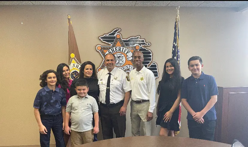 Mike Jaafar joined by his wife Angela, Sheriff Washington, the Jaafar children's Jenna, 20, Julia 18, Jad, 13, Ryan, 12, Zayn, 8. - Photo courtesy of the Jaafar family