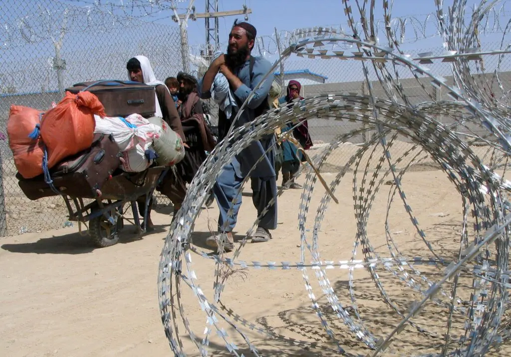 A family arriving from Afghanistan make their way through the Friendship Gate crossing point at the Pakistan-Afghanistan border town of Chaman, Pakistan August 19. Photo: Saeed Ali Achakzai/Reuters