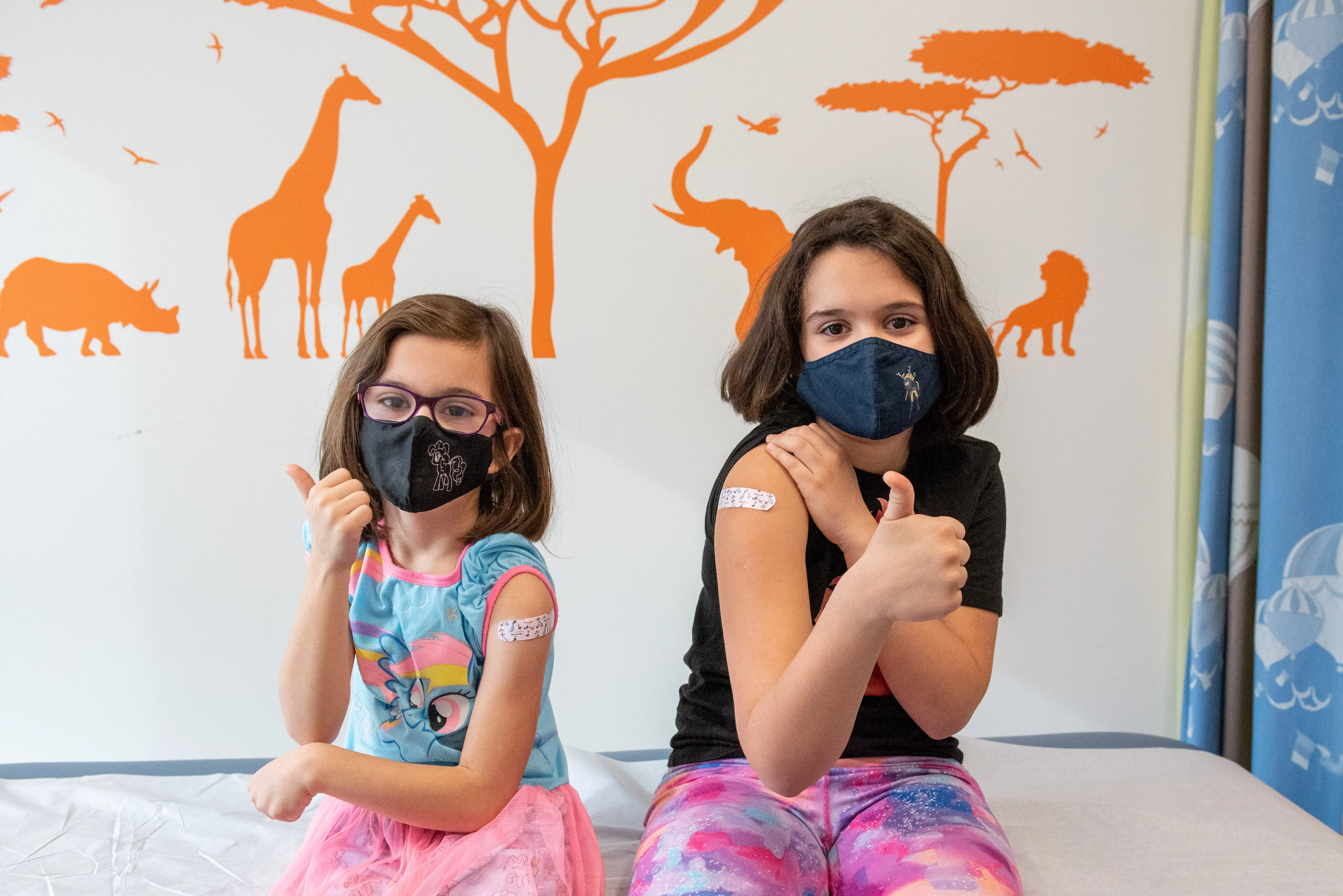 Sofia Velandia, 9, and Alana Velandia, 7, of Waterford get their first COVID-19 vaccination shots. Photo via Henry Ford Health System