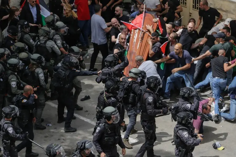 Pallbearers attacked by Israeli occupation forces drop the coffin of Shireen Abu Akleh's at her funeral on Friday, May 13. Photo: Maya Levin/AP