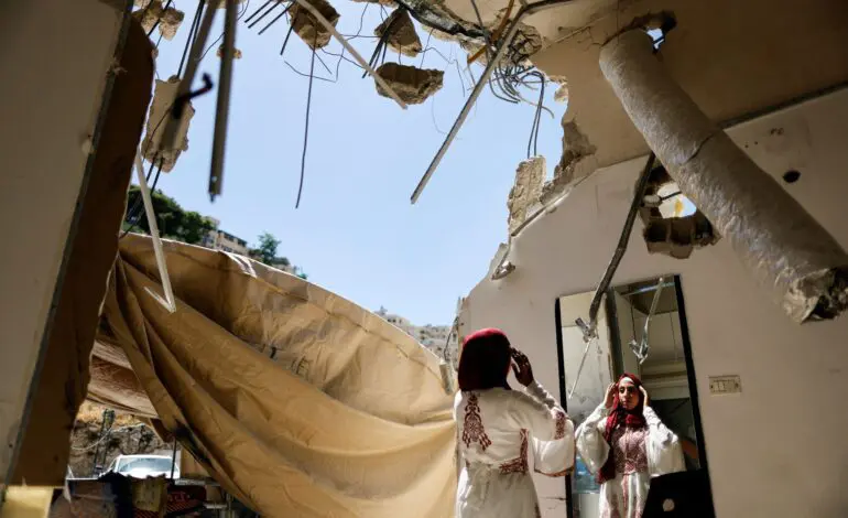 A Palestinian bride celebrates in the rubble of her demolished Jerusalem home