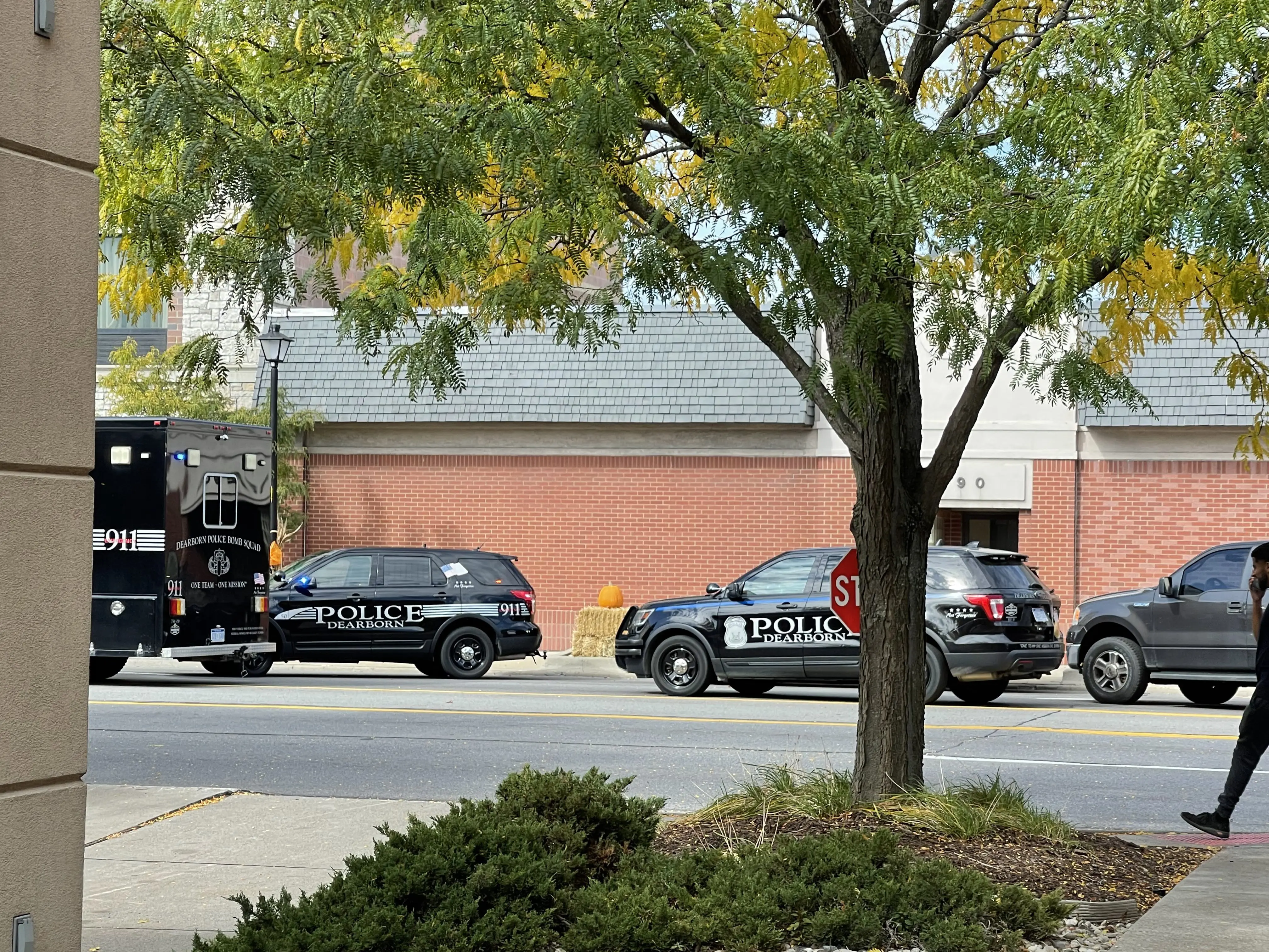 Dearborn Police squad cars and a bomb squad unit truck line Michigan Avenue outside the Hampton Inn Thursday afternoon during an active shooter situation at the hotel, Oct. 6. Photo: The Arab American News