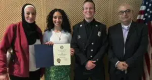 Amneh Yaghmour receiving her recognition from Dearborn Fire Fighter in the presence of her parents. Videograb