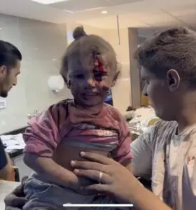 A child victim of the bombing of Al-Ahli al-Arabi hospital late on Tuesday sitting by her injured mother.