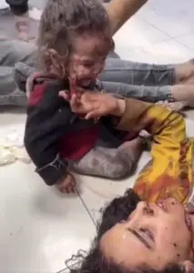 A child victim of the bombing of Al-Ahli al-Arabi hospital late on Tuesday sitting by her injured mother