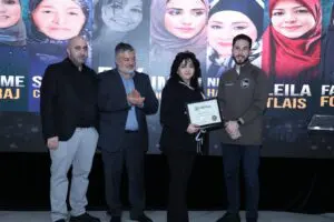 Hassan Baydoun, Abbas Shehab and Mayor Hammoud presenting an award to a relative of the late Fay Awada, who was one of the honorees. – Photos by Abbas Shehab
