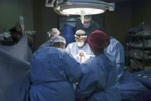 Doctors perform surgery on a patient at Al-Aqsa Martyrs Hospital, in Deir al-Balah, central Gaza, Sunday, March 17, 2024. An international team of doctors has been working the past two weeks at the facility amid shortages of supplies. - Photo by AP