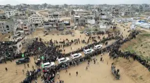 A drone view shows Palestinians and militants gathering around Red Cross vehicles on the day Hamas hands over the bodies of deceased hostages as part of a ceasefire and hostages-prisoners swap deal between Hamas and Israel, in Khan Younis in the southern Gaza Strip, February 20. – Photo by Reuters