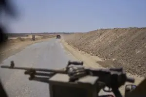 Israeli occupation army vehicles transport a group of soldiers and journalists along the Morag corridor in southern Gaza on June 8, 2025. - Photo by AP 