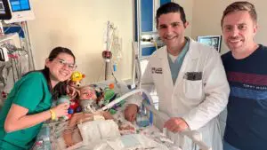 Mohamad Bydon, chair of the Department of Neurological Surgery at UChicago Medicine, with 2-year-old Oliver Staub and his parents, Laura and Stefan Staub. – Photo courtesy of the Staub family