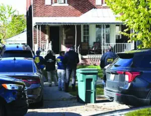 Federal agents search a house on Horger Street in East Dearborn on the eve of Halloween.