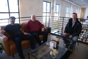 Owners Hussein Siblini (right) and Mohamad Yassine (left) have a conversation with Osama Siblani on the second floor of Saj Bakery in Canton.