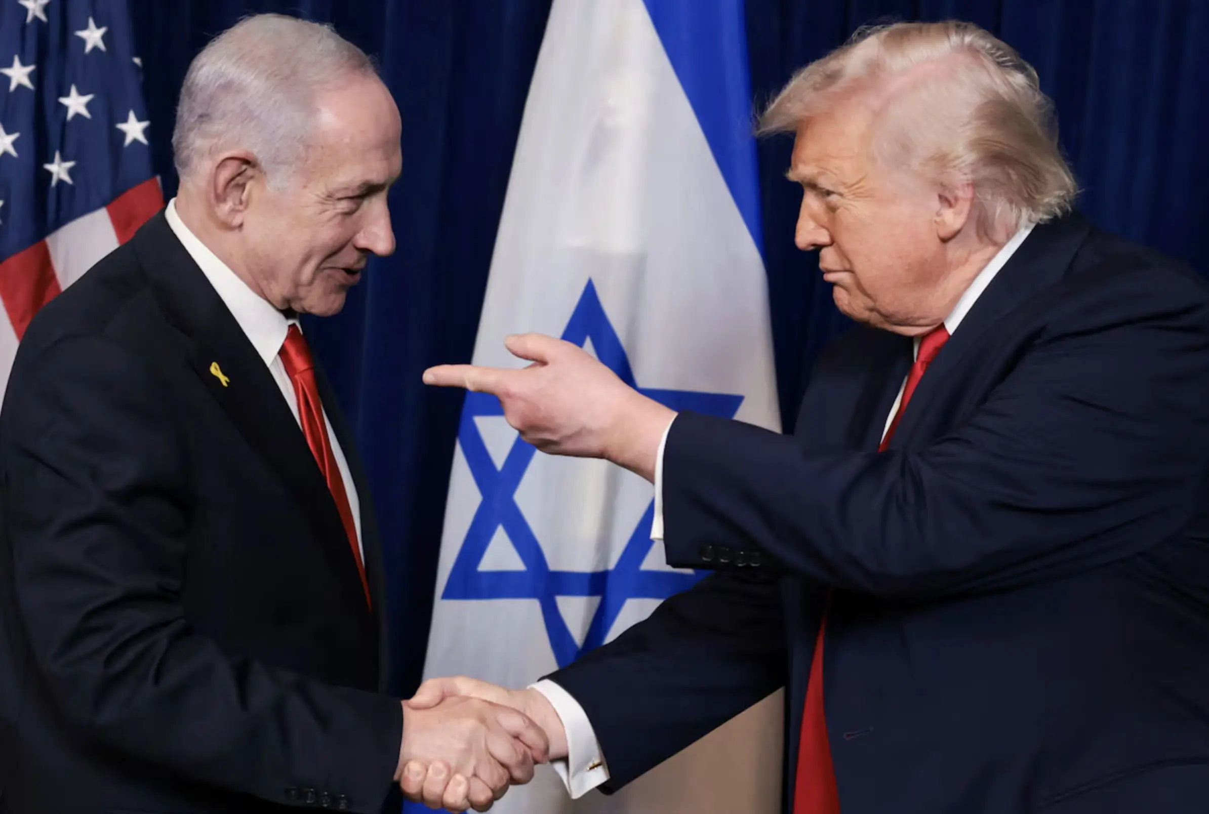 President Donald Trump points his finger towards Israeli Prime Minister Benjamin Netanyahu as they shake hands during a press conference after meeting at Trump’s Mar-a-Lago club in Palm Beach, Florida, U.S., December 29, 2025.