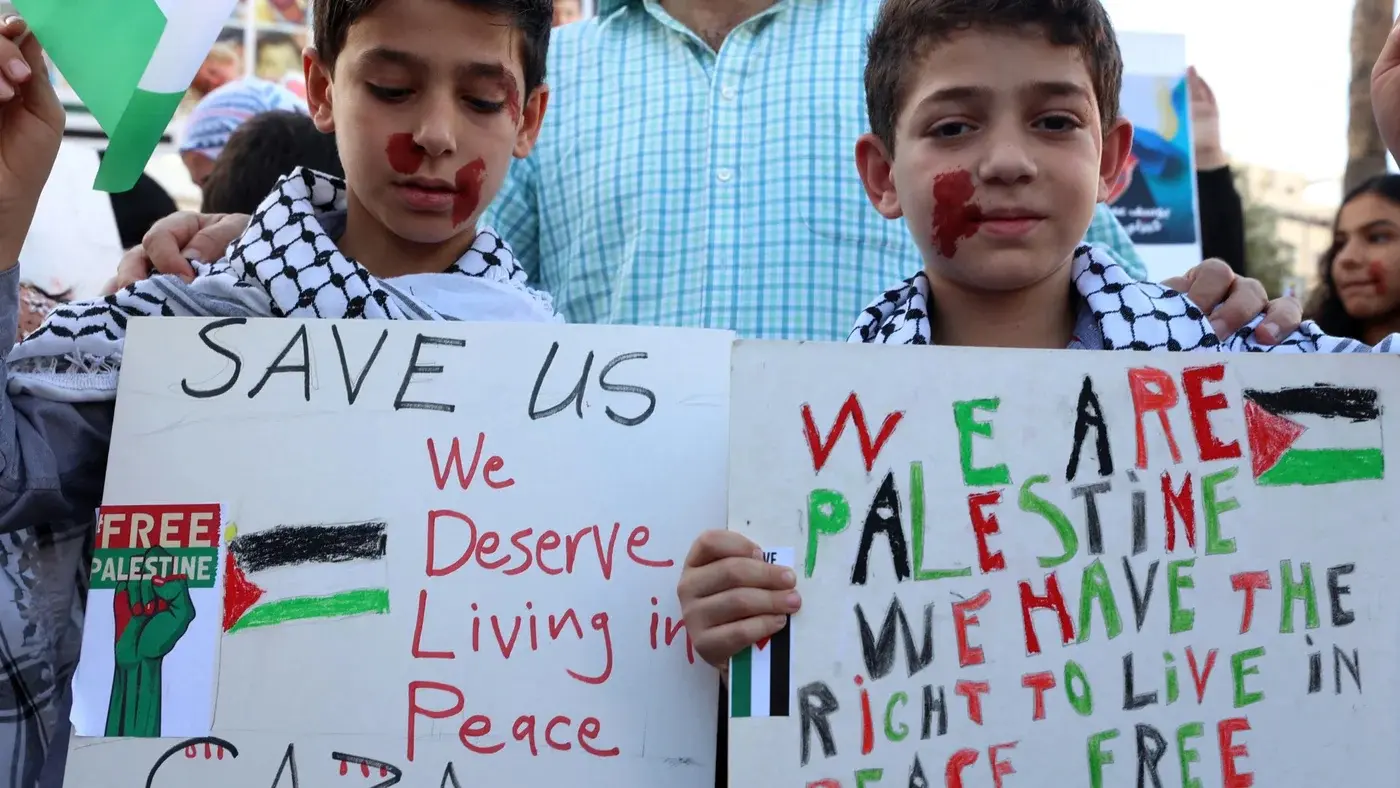 Palestinian children hold posters during a protest in solidarity with children in the Gaza Strip, in the city of Ramallah, 4 November 2023 - File photo
