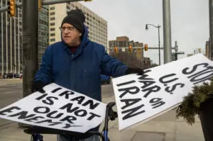 Dozens of protesters gathered Saturday along Jefferson Avenue in front of Hart Plaza to protest U.S. military strikes on Iran. - Photo by the Detroit News