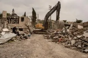 A man who lost two of his sons searches for the body of one of them in the rubble, the day after the cease-fire took effect, in Arnoun, Lebanon, on April 17,