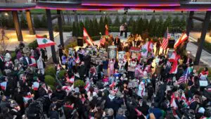 Protesters raise Lebanese flags at Peace Park in west Dearborn, Friday, April 10. – Photo by Dearborn.org