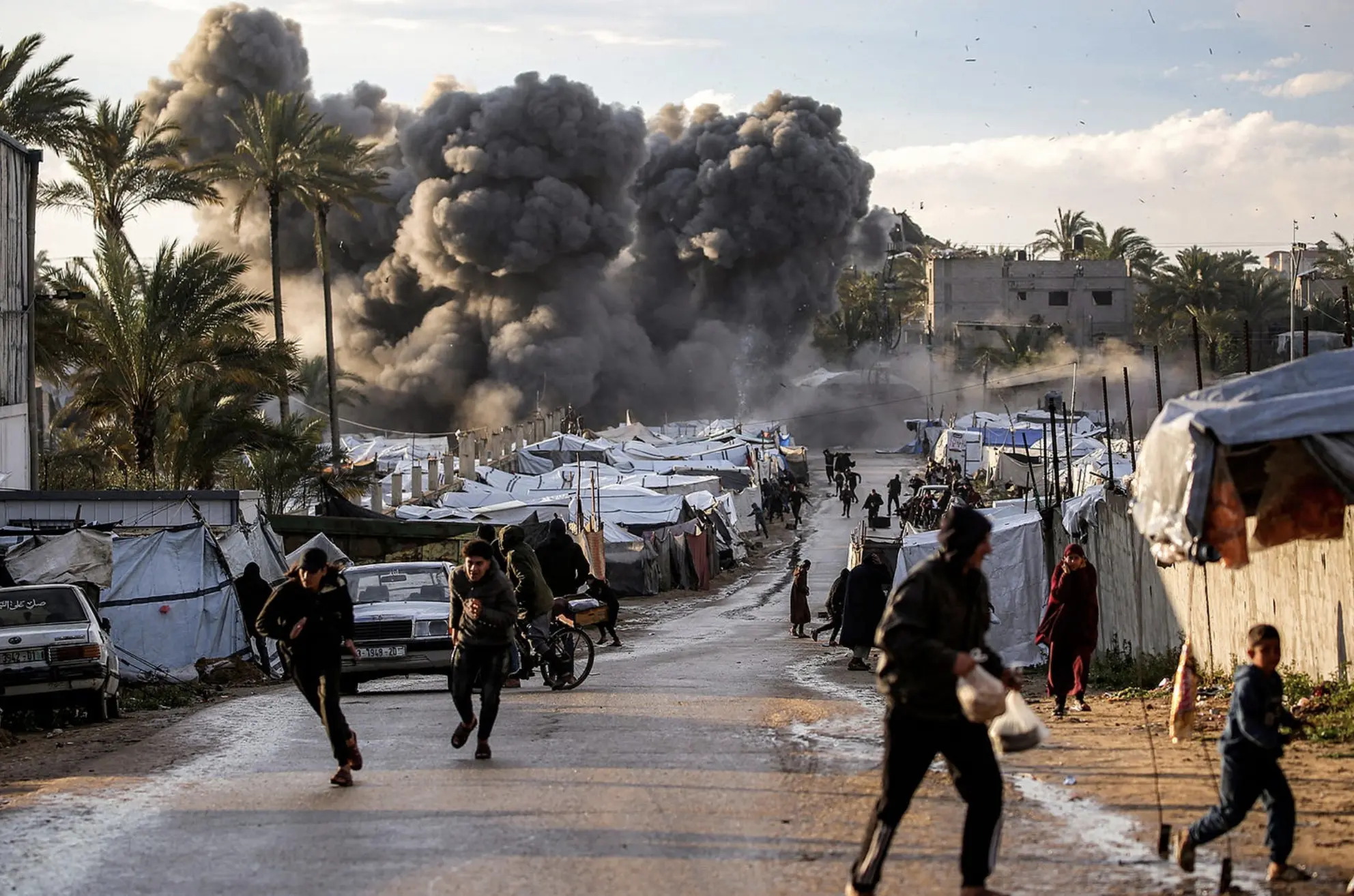 People flee following an Israeli strike near a tent encampment in Gaza on March 25. Photo by AFP 