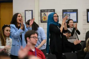 Applause erupts inside the Dearborn Board of Education chamber after the announcement naming Mike Esseily as superintendent of Dearborn Public Schools.