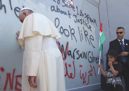 Pope Francis prays at the wall of separation in Bethlehem