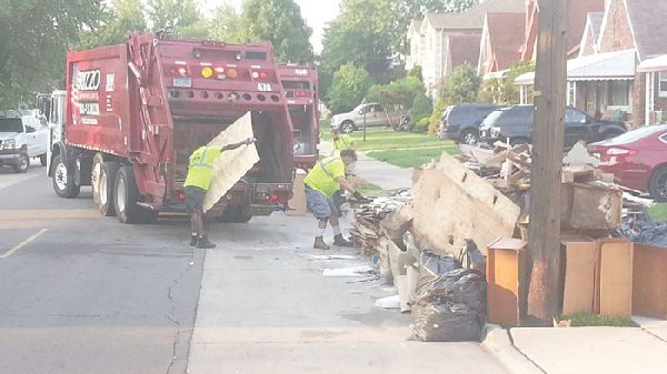 125 trash trucks sweep through Dearborn’s neighborhoods, remove flood damaged items