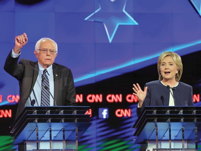 Clinton, Sanders take new combative tone ahead of New Hampshire primary