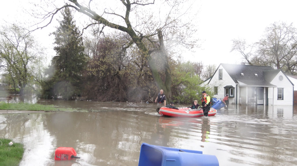 Dearborn Heights firefighters recuing residents trapped in their homes by flood on Tuesday, May 1