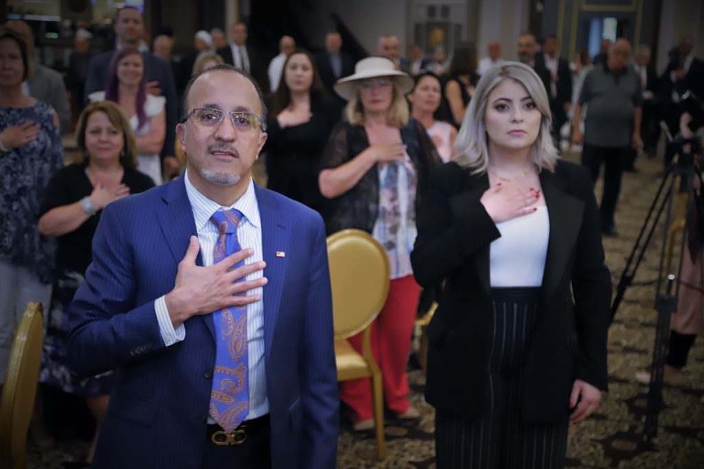 Councilman Dave Abdallah pays respect to the national anthem beside his daughter during the fundraising event at the Bellagio Banquet Center in Dearborn Heights, Wednesday, June 12 - Photos by Abbas Shehab