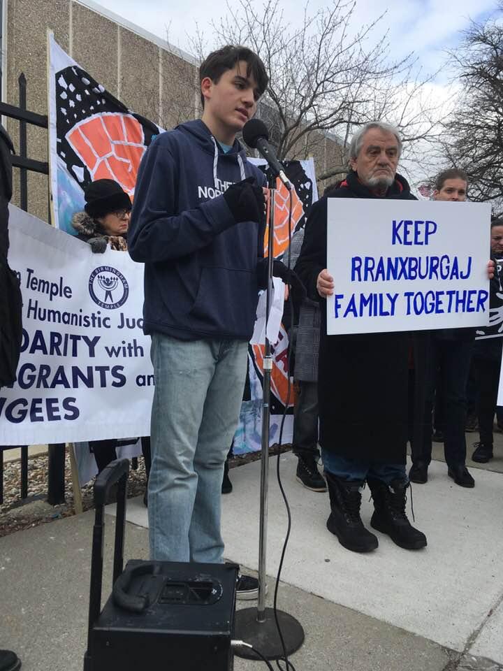 Ded and Flora Rranxburgaj's younger son, Eric, speaks on his father's behalf outside ICE offices in Detroit