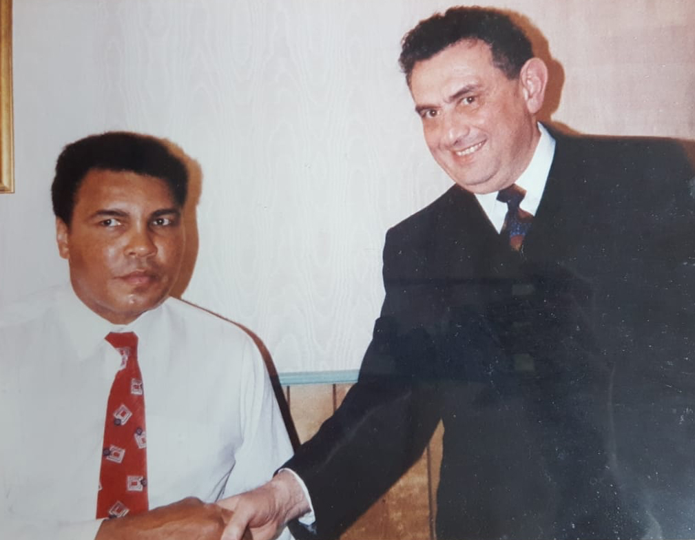 Mohammed Turfe shakes hands with the legendary boxer Muhammad Ali