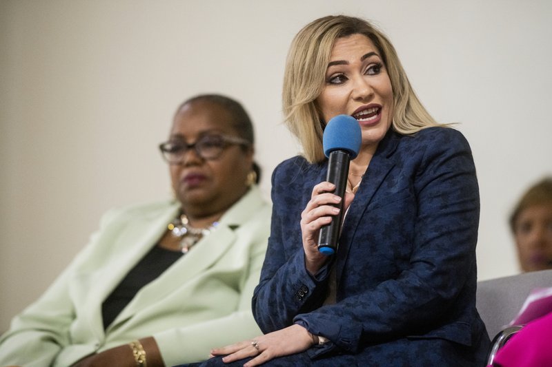 Michigan Solicitor General Fadwa Hammoud and Wayne County Prosecutor Kym Worthy address frustrated residents at a UAW hall in Flint. Photo: Jake May/AP