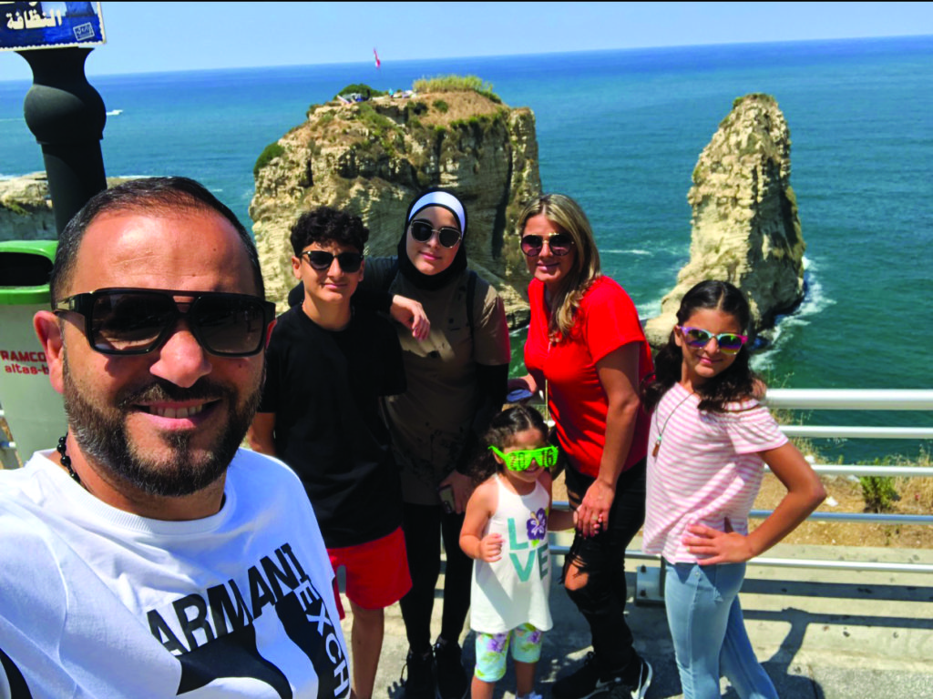 The family of Marwan Faraj, his wife Chirrine, daughters Batoul, Ayat, Lamees and son Mohamad are posing in a selfie and behind them is the iconic rock of Raouche' in Beirut, Lebanon