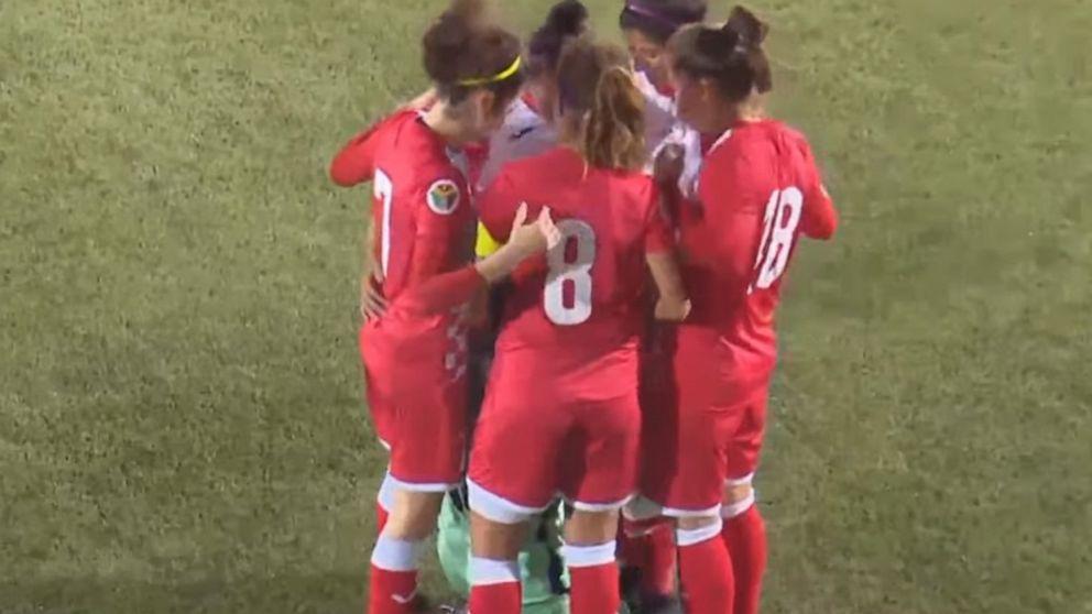 Jordanian soccer team huddles around opposing player during game ...