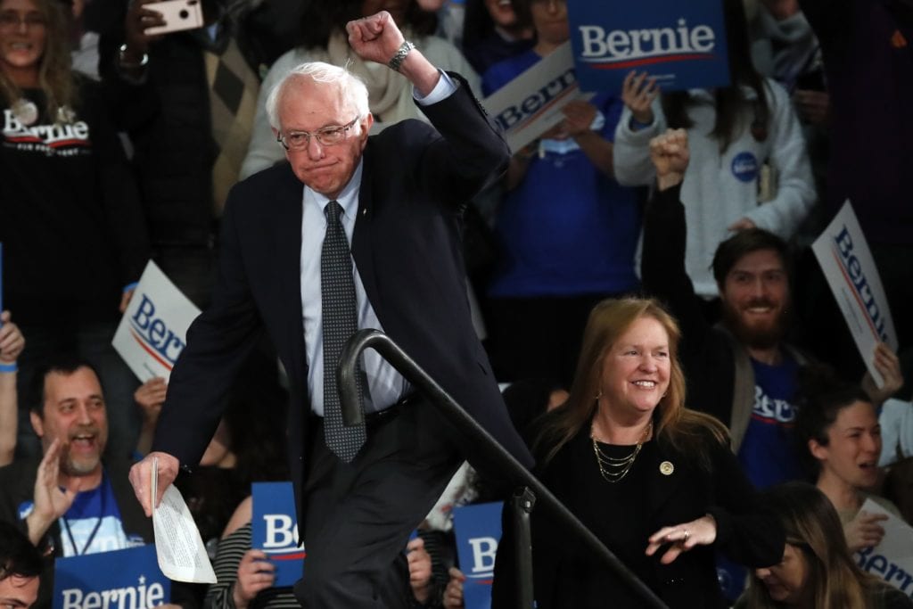 Sen. Bernie Sanders, I-Vt., with his wife Jane O'Meara Sanders, speaks to supporters at a caucus night campaign rally in Des Moines, Iowa, Monday, Feb. 3. -Photo by AP