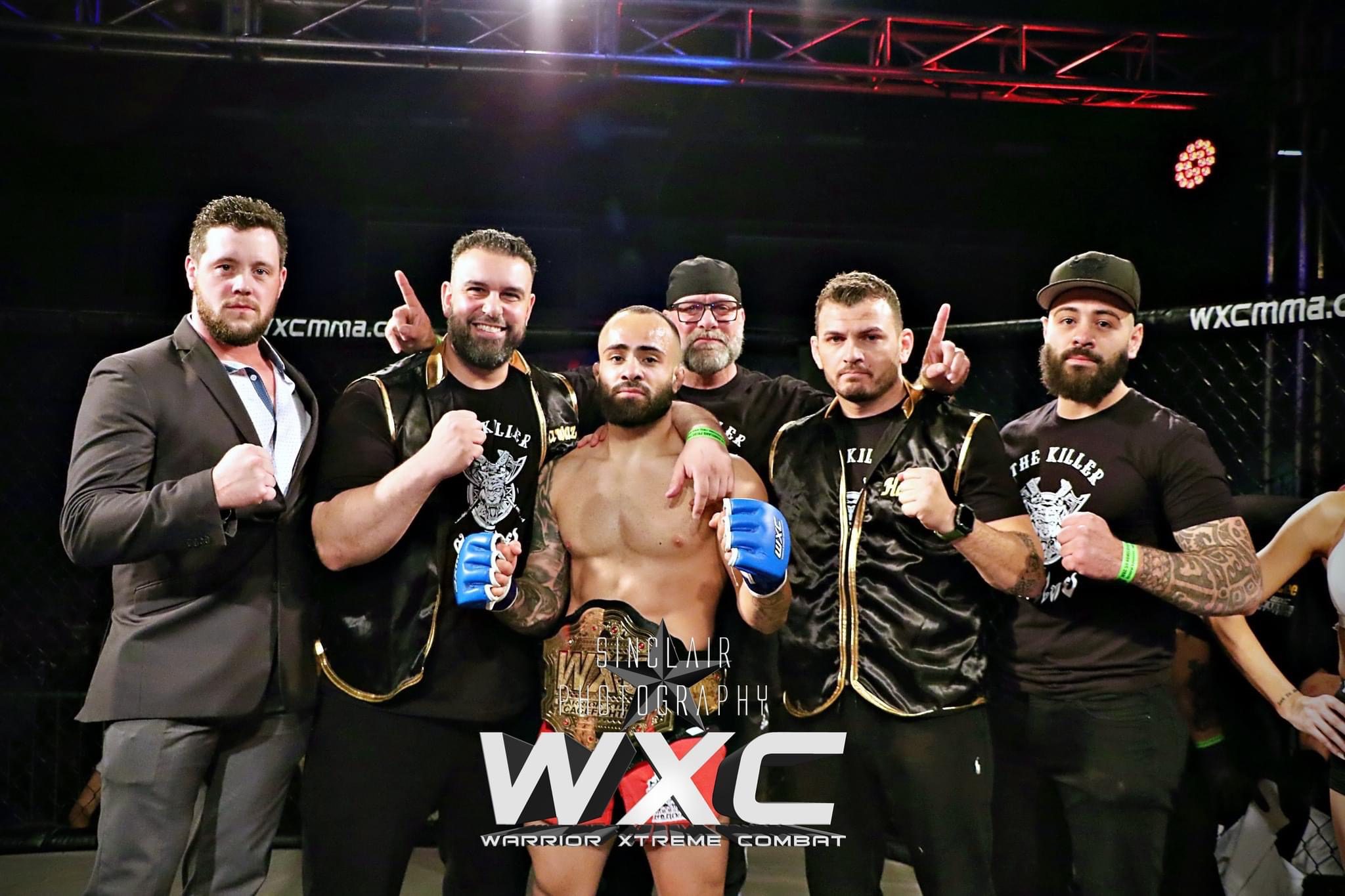 Abe Alsaghir celebrates a successful MMA fight, surrounded by Detroit Jiu-Jitsu coaches (left to right) Shea Butler (wrestling), Anthony Fawaz (DJJ co-owner), Tony Callino (boxing), Ali "The Butcher" Hamka (kickboxing). Also pictured is Abe's brother Fouzi (far right). Photo courtesy: Abe Alsaghir/Sinclair Photography