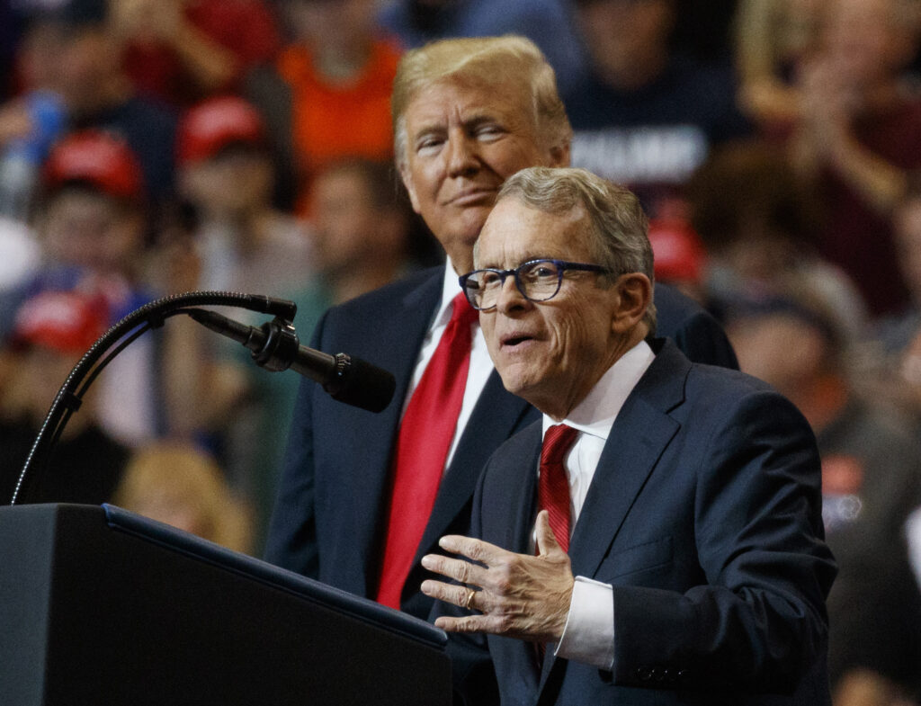 President Donald Trump stands with gubernatorial candidate Mike DeWine as he speaks during a rally, at the IX Center, in Cleveland, Monday, Nov. 5, 2018. (AP Photo/Carolyn Kaster)
