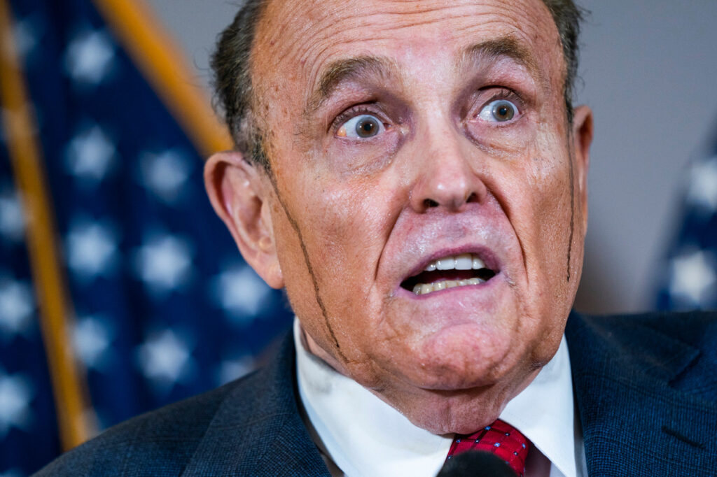 Trump's lawyer Rudy Giuliani speaks to reporters, with hair dye running down his face, on Thursday. Photo: EPA