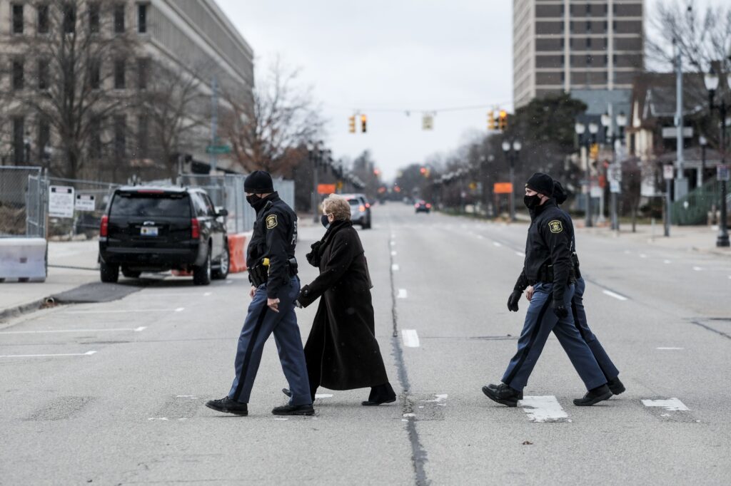 An electoral voter is escorted by Michigan State Police in Lansing on Dec. 14. Photo: Matthew Hatcher/Bloomberg