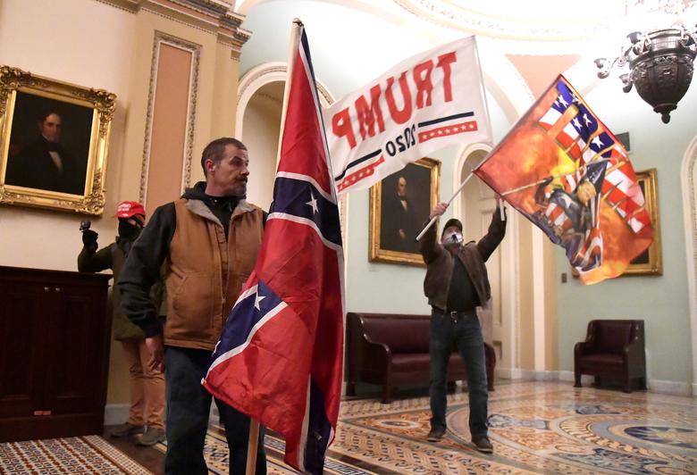 Kevin Seefried holds a Confederate flag after illegally breaking into the U.S. Capitol on Jan. 6. Seefried was later arrested by the FBI, as have hundreds of others that stormed the highly restricted building that day, a siege which led to the death of police officer. Photo: Reuters