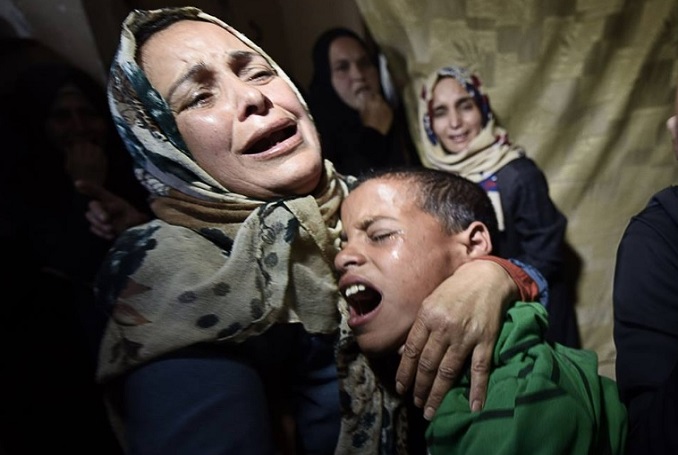Mother and brother of Tahrir Mahmoud Wahba mourn him in Khan Younis, Gaza. – File photo