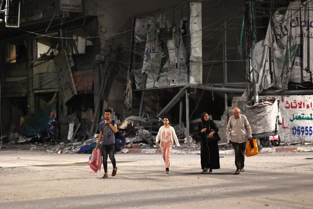 Palestinian families are pictured in a street after evacuating their homes east of Gaza City on May 13, on Eid Al-Fitr, due to heavy shelling by the Israeli military. Photo: AFP