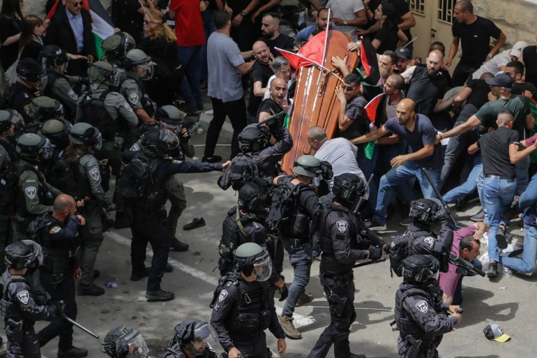 Pallbearers attacked by Israeli occupation forces drop the coffin of Shireen Abu Akleh's at her funeral on Friday, May 13. Photo: Maya Levin/AP