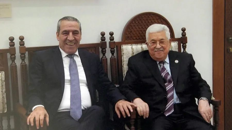 Palestinian Authority Chairman Mahmoud Abbas (right) sits with rumored successor Hussein Al-Sheikh. Photo: Moroccan press via JCPA